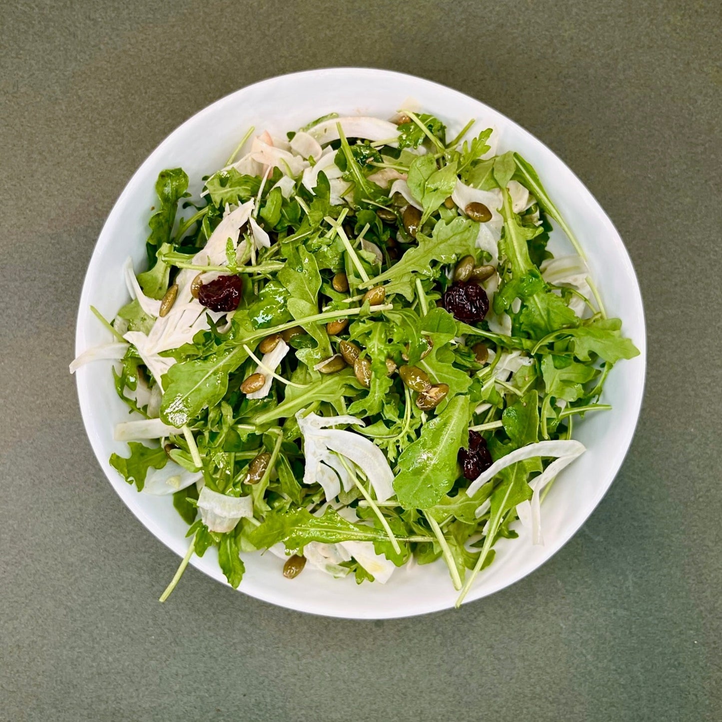 Arugula Salad with Cider Vinaigrette, Seeds, Fennel, and Dried Cherries