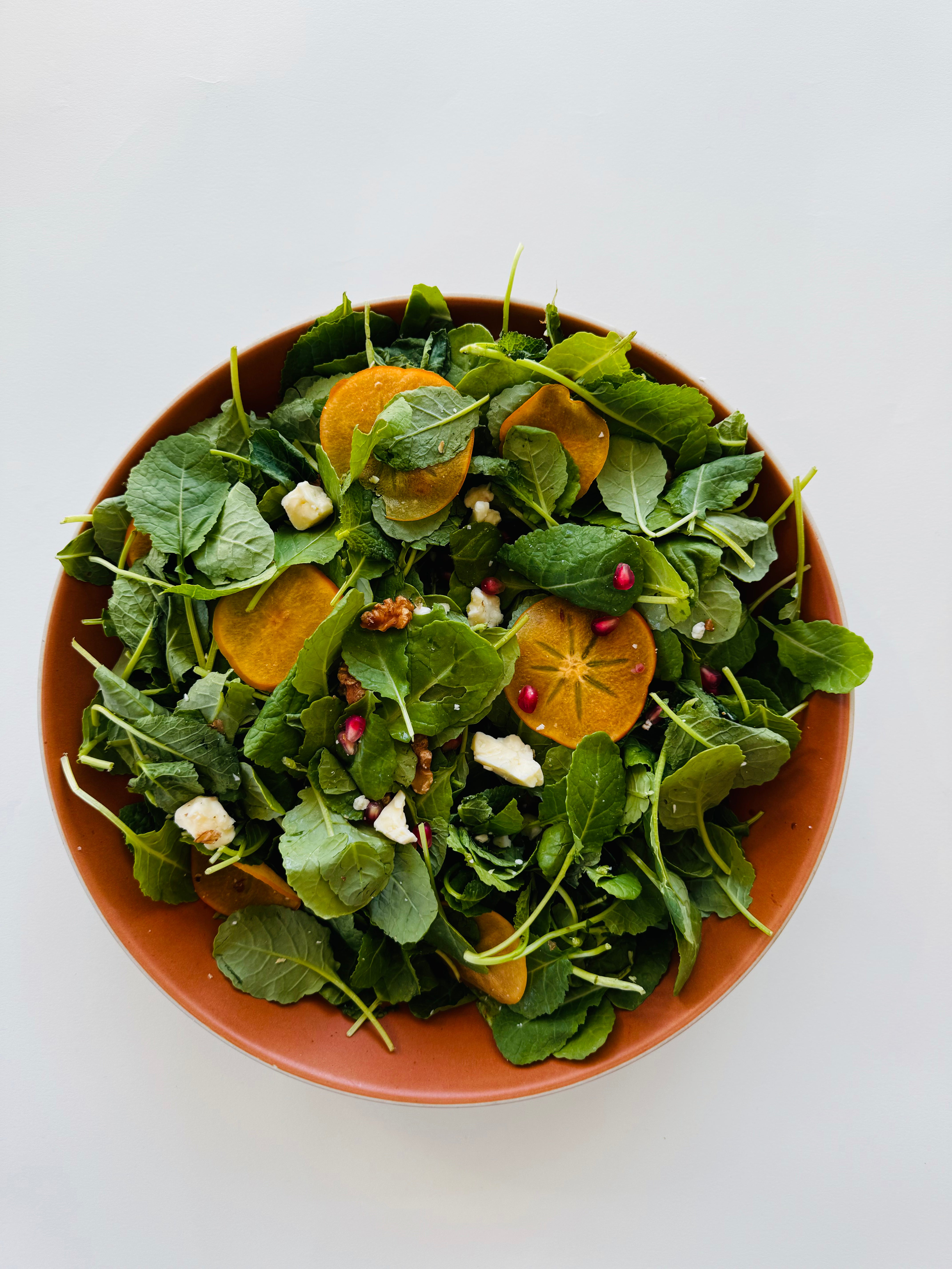 Baby Kale Salad with Persimmon, Walnut, and Aged Cheddar