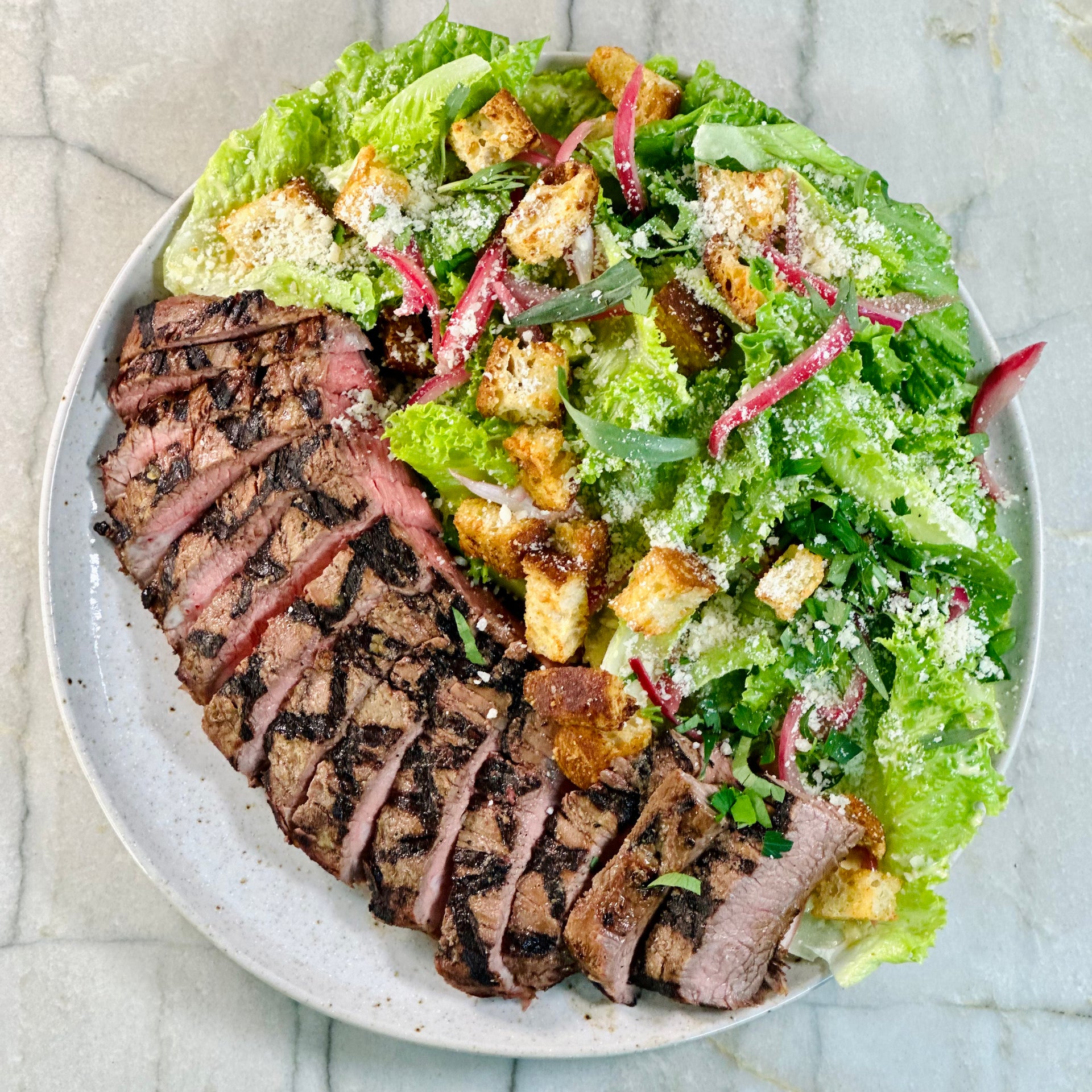 Grilled Flank Steak over Kale Caesar Salad